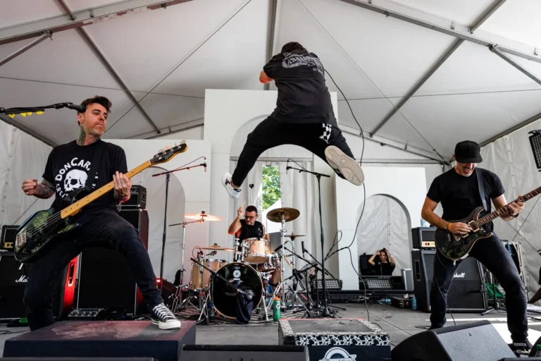 Singer jumping above the drum kit — Punchline 13, Vans Warped Tour Montreal 2026