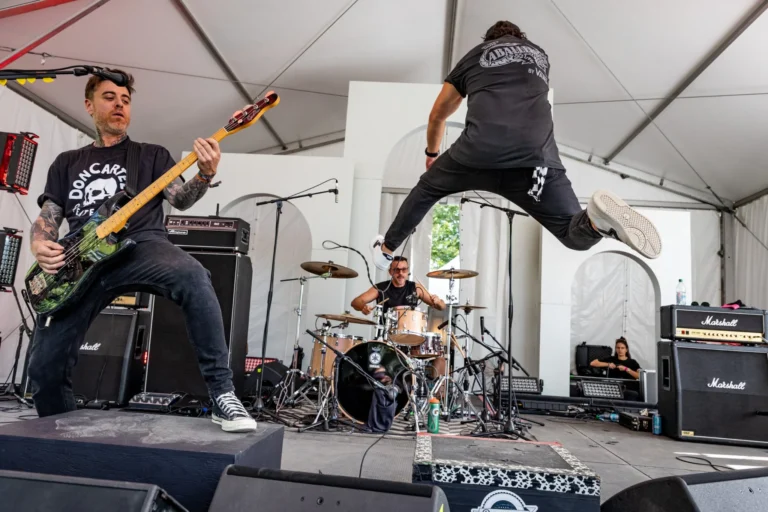 Live stage action with singer mid-jump — Punchline 13, Vans Warped Tour Montreal 2026